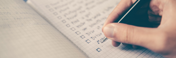 Person writing a checklist